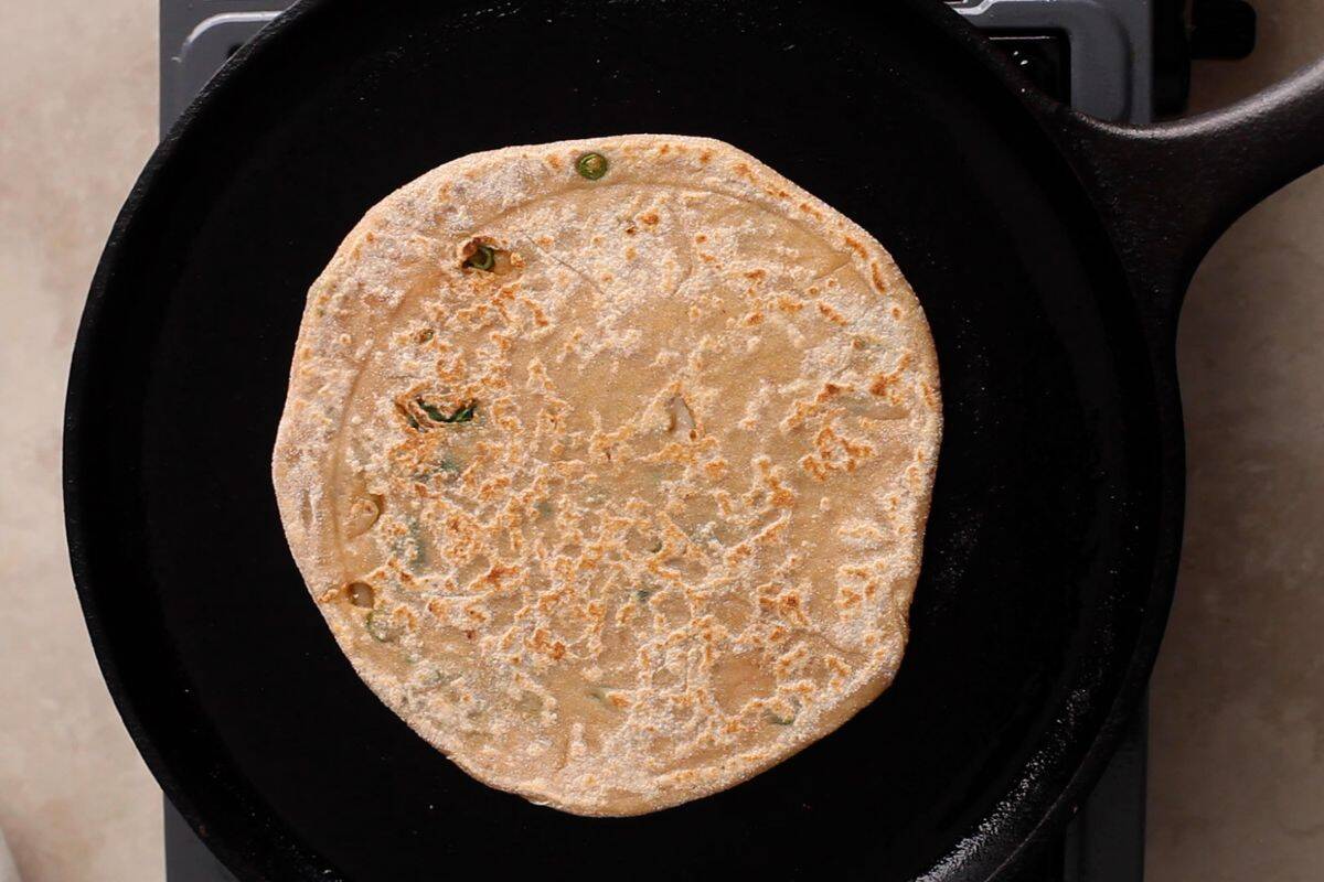 Punjabi Mooli Paratha (Stuffed Radish Paratha) 17 Paratha is cooked on a cast iron griddle.