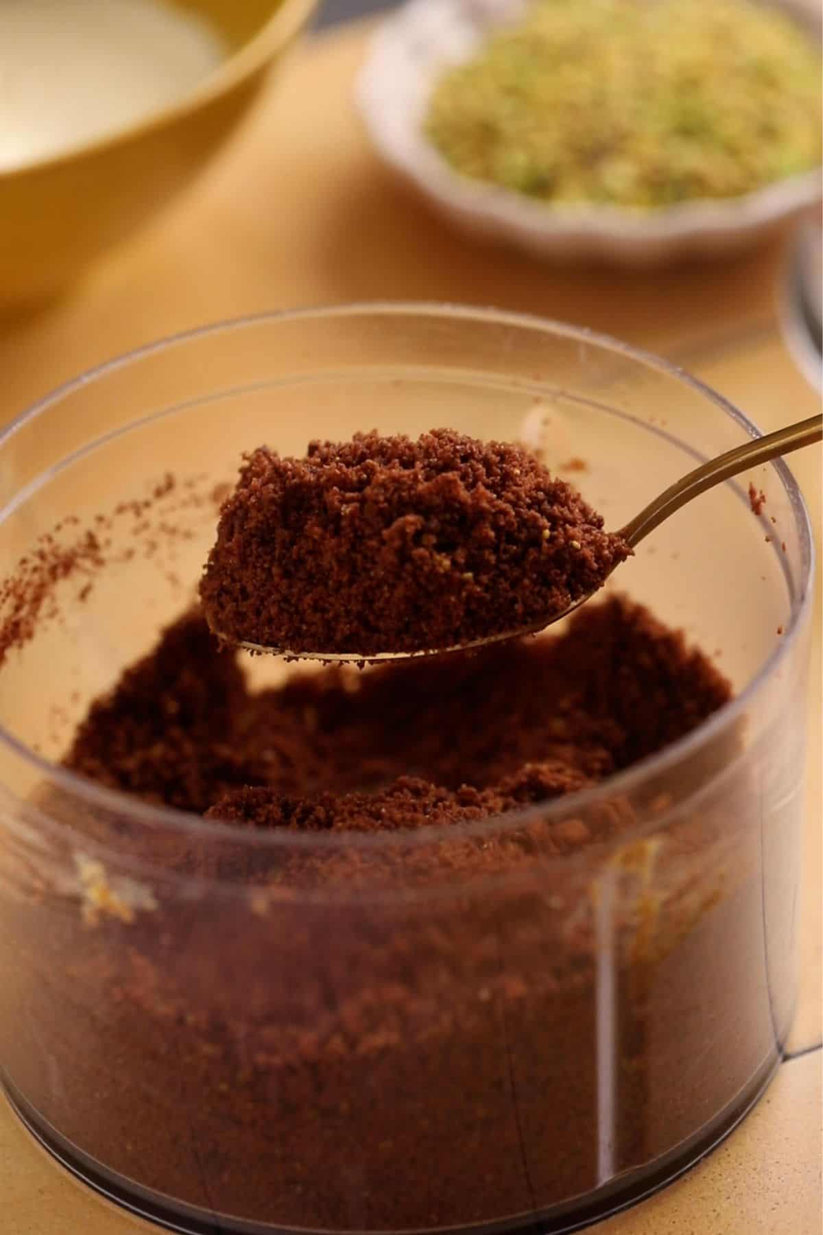 No Bake Pistachio Cheesecake Cups 11 Cookie crumbs in a small spoon.