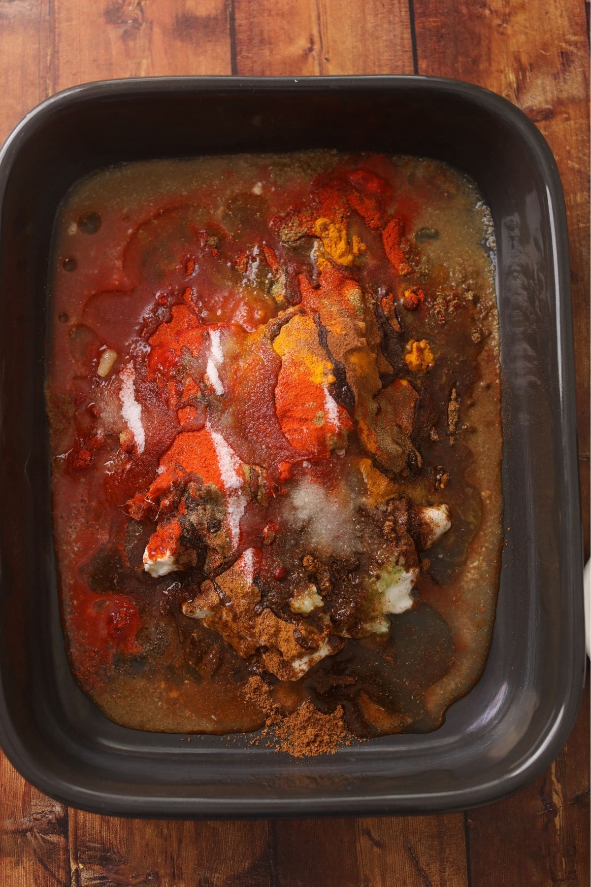 Marinade ingredients in a large black rectangular bowl. 