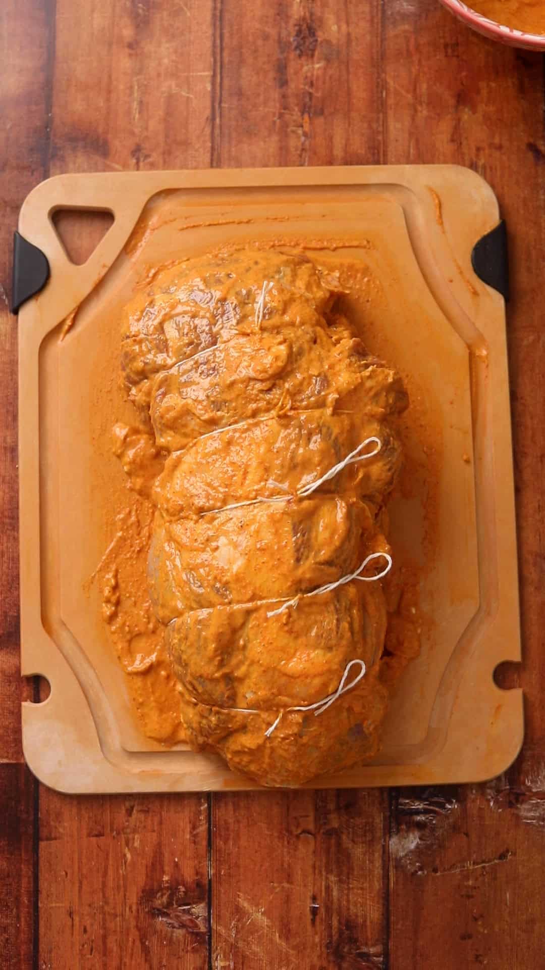 Lamb leg is tied with butchers twine.