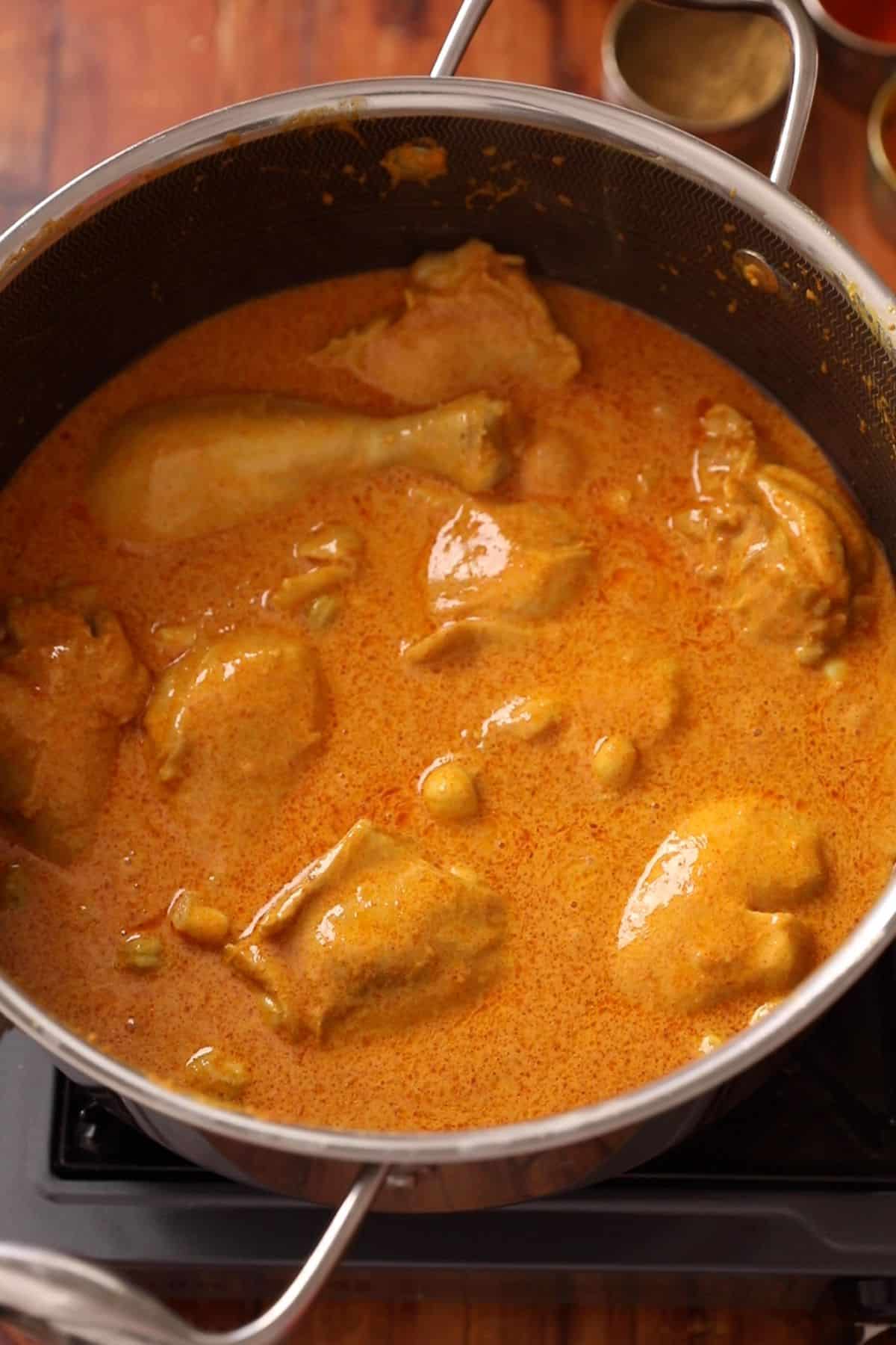 Chicken is cooked with yogurt and spices until yogurt is warmed through.