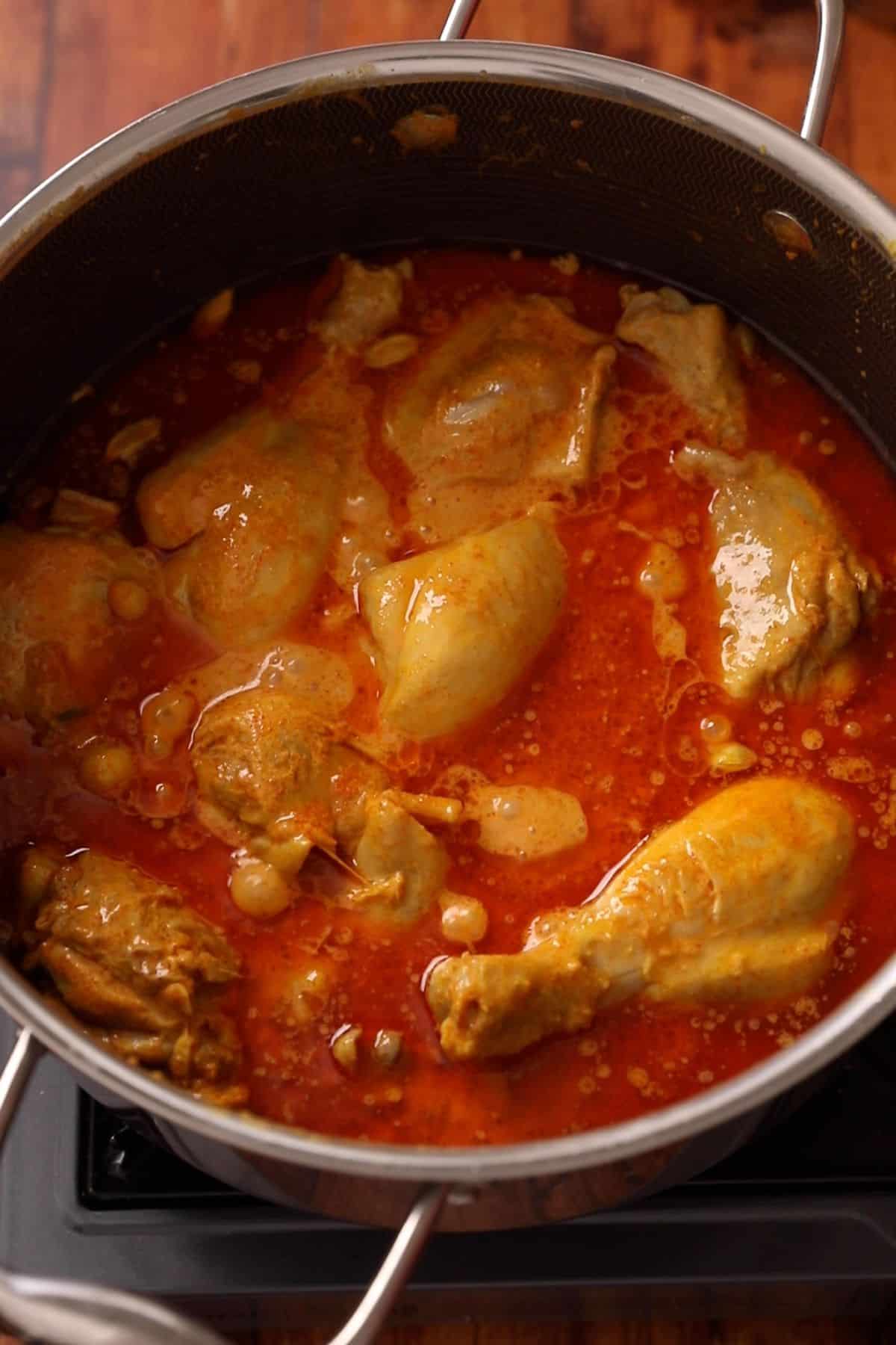 Chicken continues to cook in yogurt and spices  until the oil separates and chicken is par cooked. 