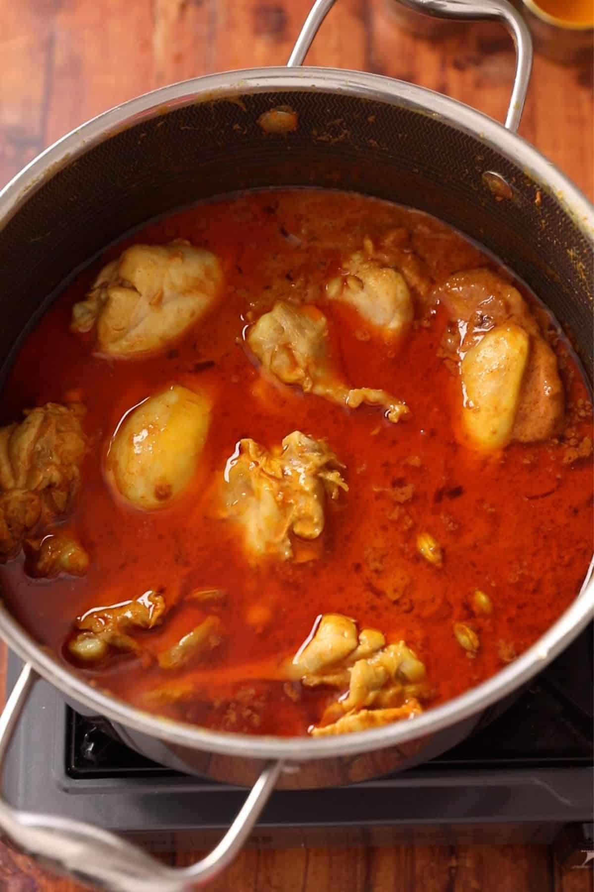 Chicken is added back to the korma gravy.