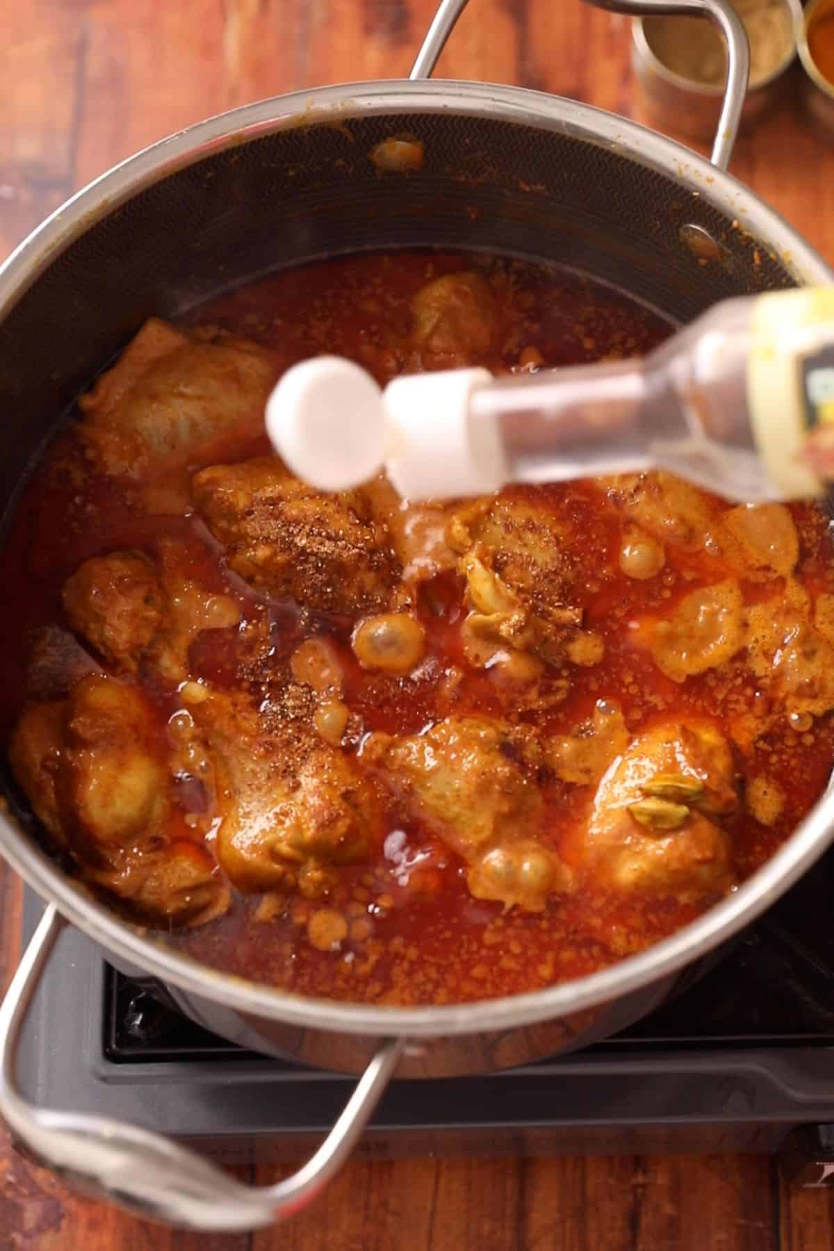 Delhi chicken korma is finished with spices and kewra water.