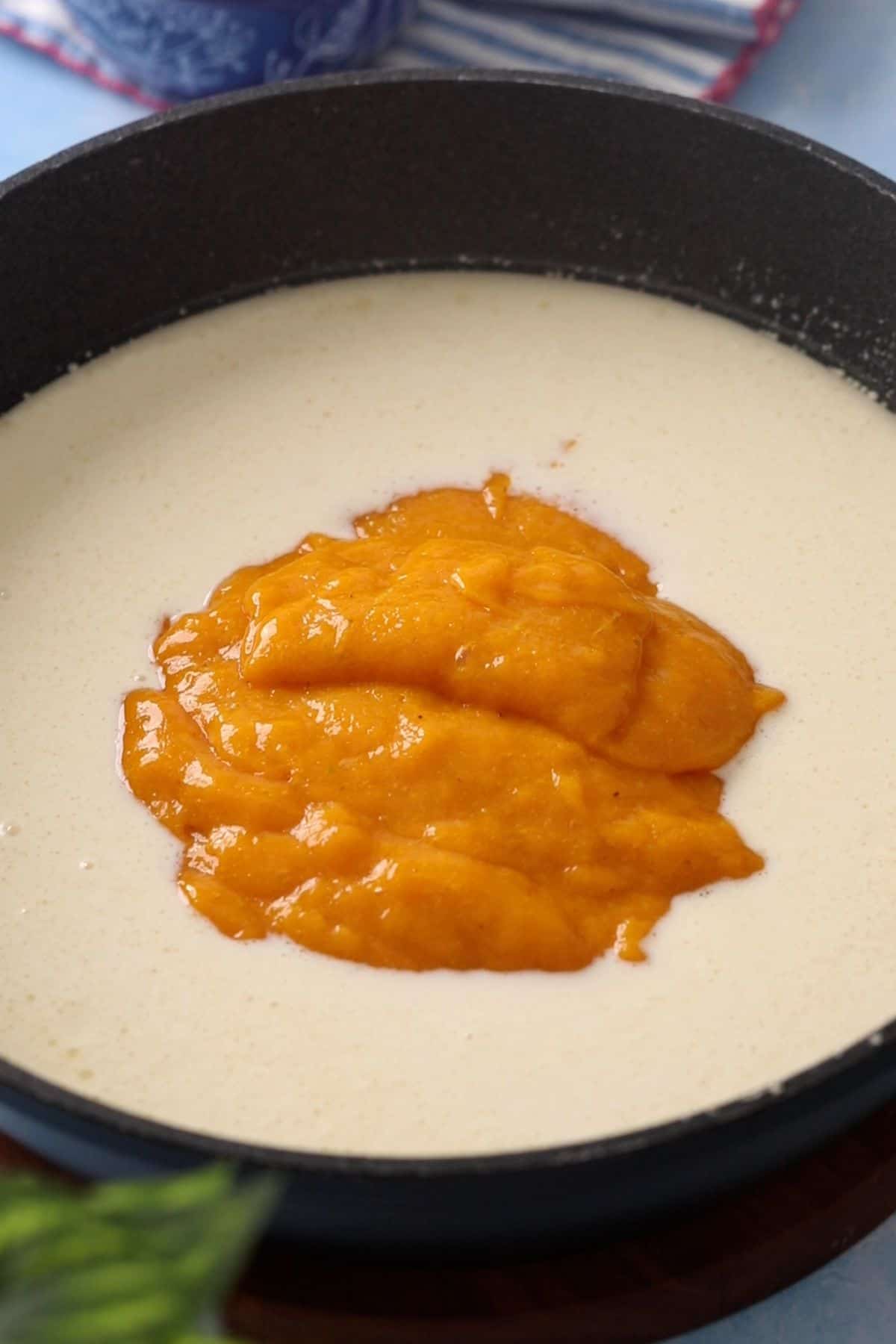 Mango puree is added to the milk mixture.