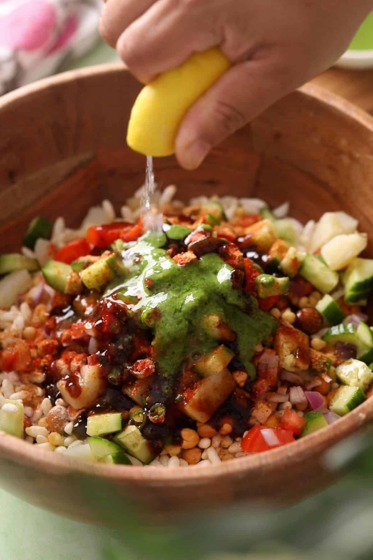 Chutneys, spices and lemon juice is added to the bhel ingredients.