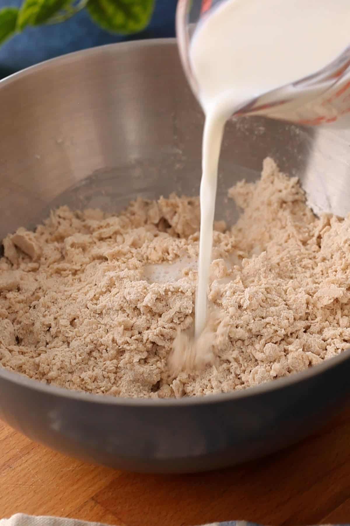 Milk is added to the atta mixture.