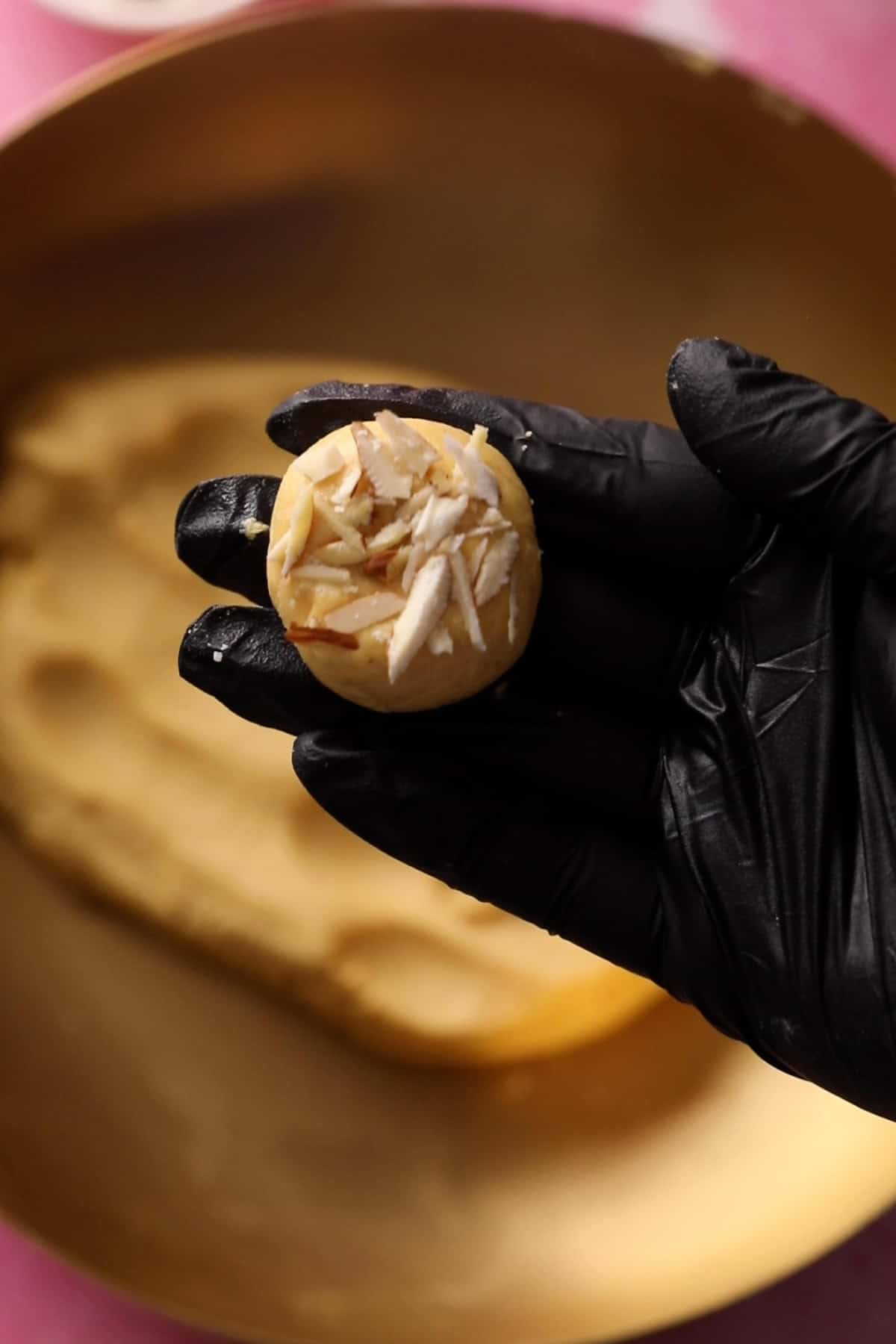 Nankhatai are topped with sliced almonds.