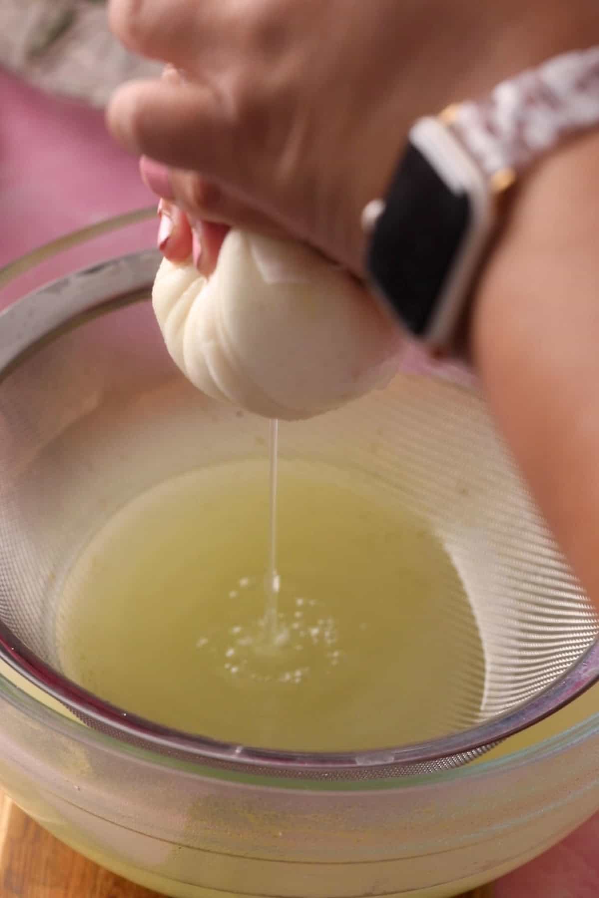 Chenna is being squeezed to get rid of whey.
