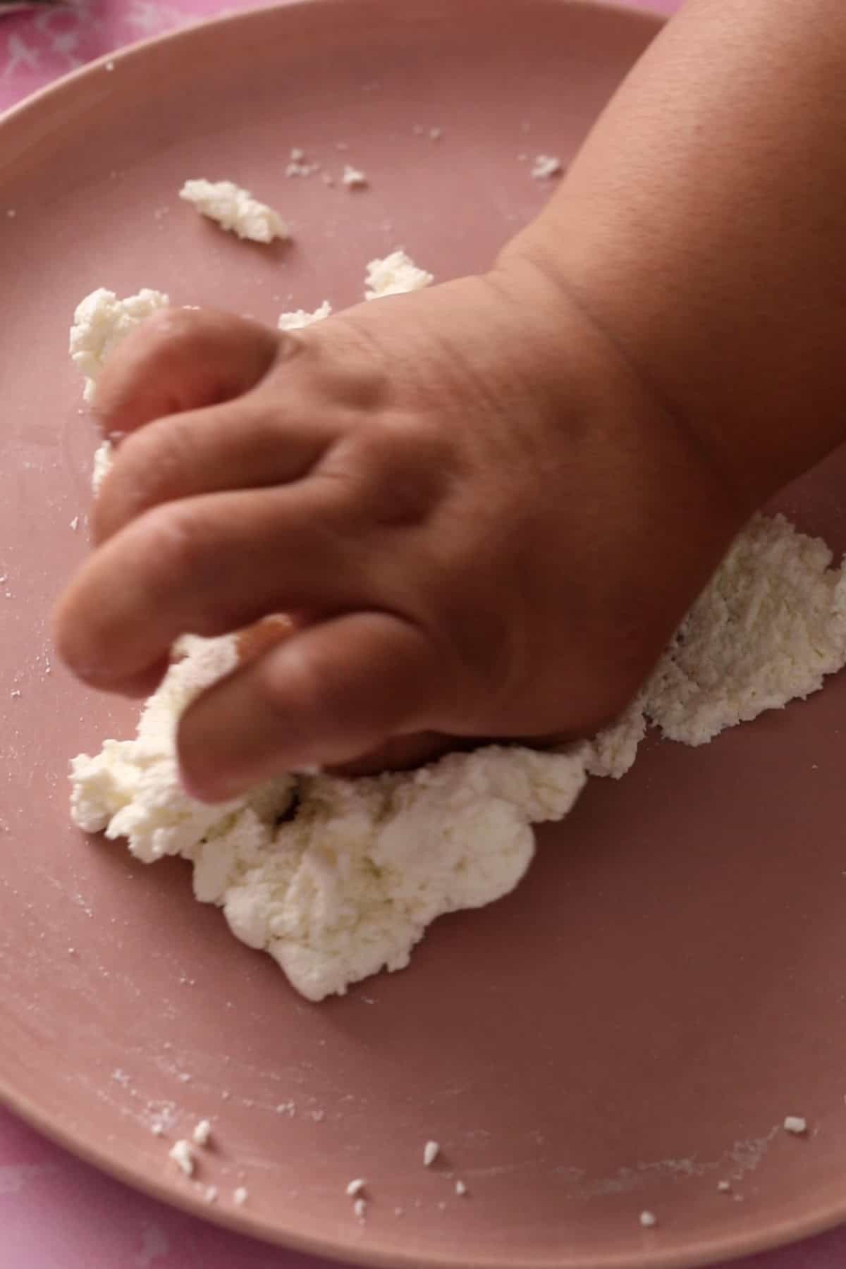 Kneading chenna using the heel of palm.