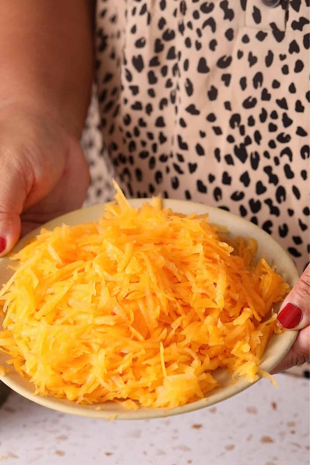 Shredded pumpkin in a brown plate.