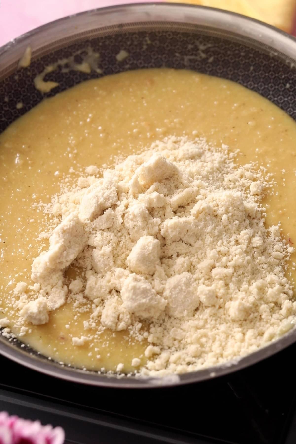 Almond flour is added to the khoya mixture.