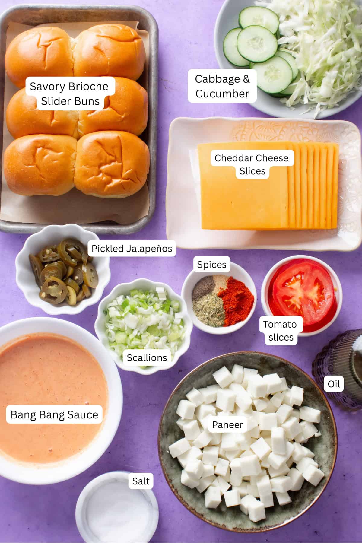 Ingredients Needed to make paneer sliders are placed on a lilac colored background.