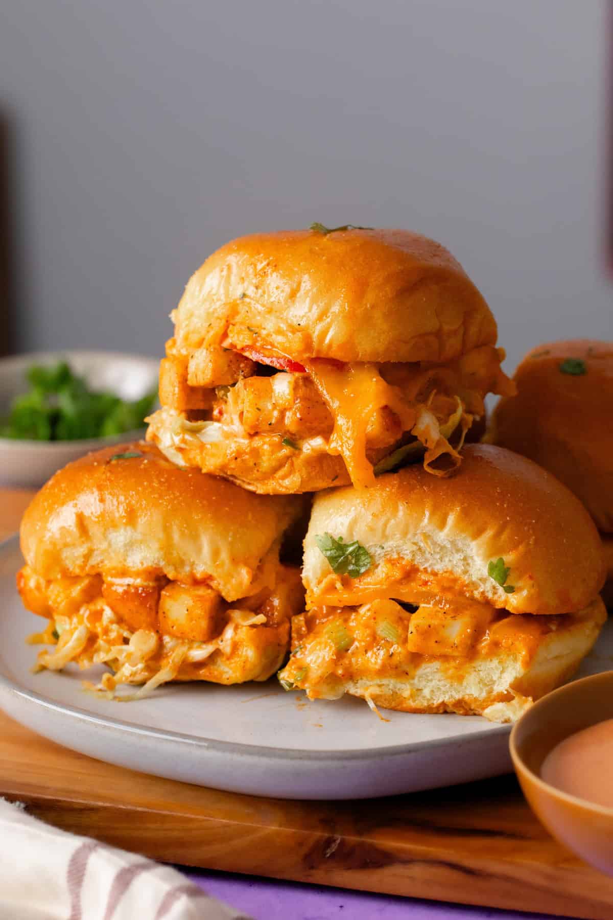 A stack of bang bang paneer sliders on a white plate. 