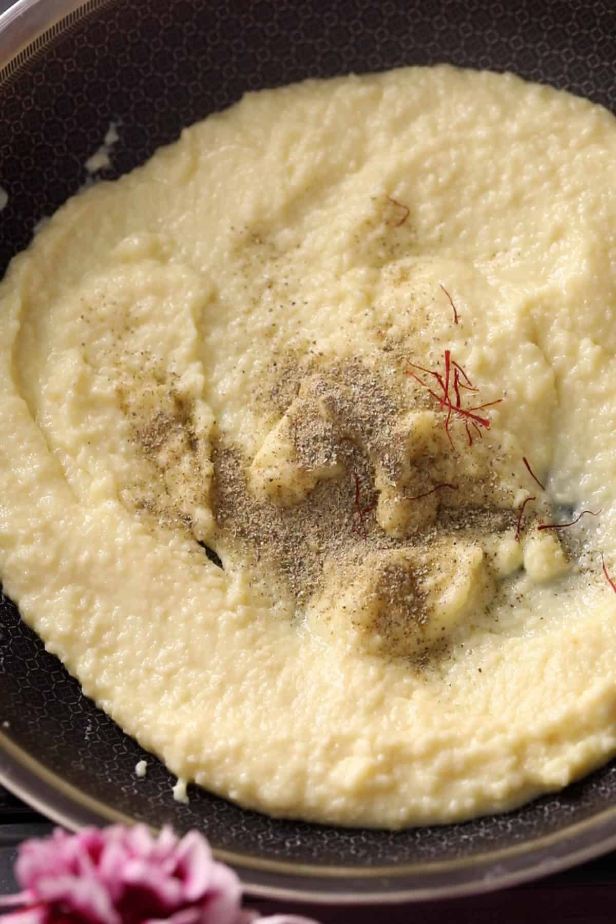 Softened Khoya sprinkled with cardamom powder and saffron.