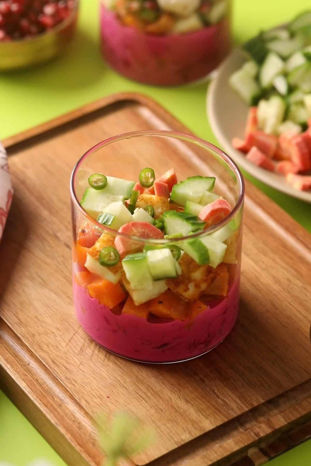 Vegetables are layered over beet yogurt and paneer.